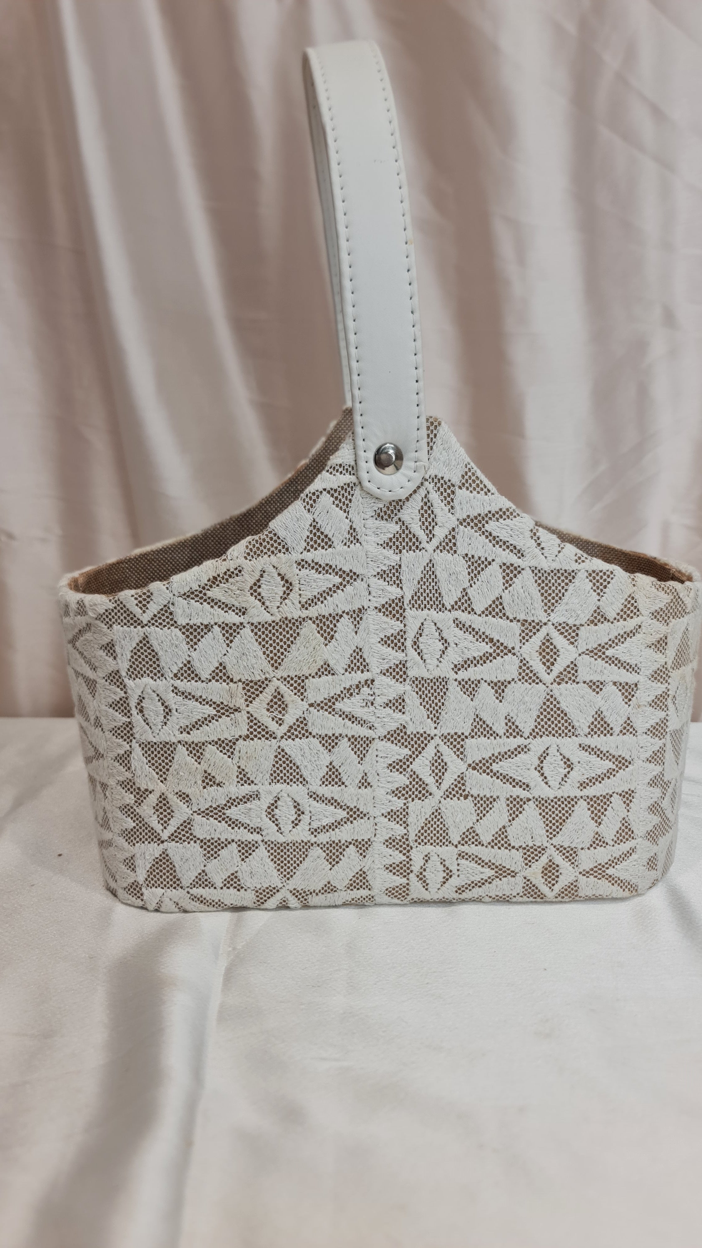 Patterned handbag on a light fabric background