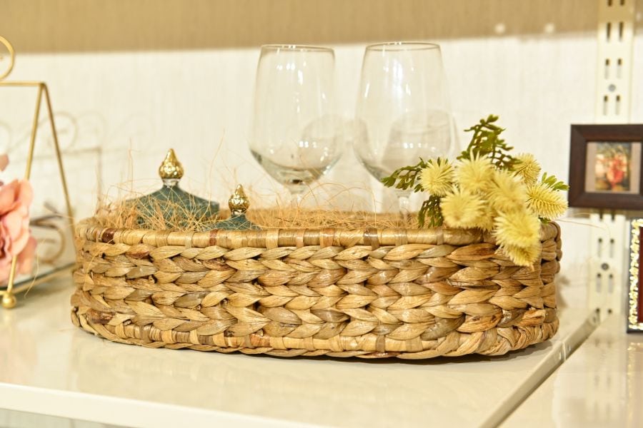 Woven basket with decorative items on a surface