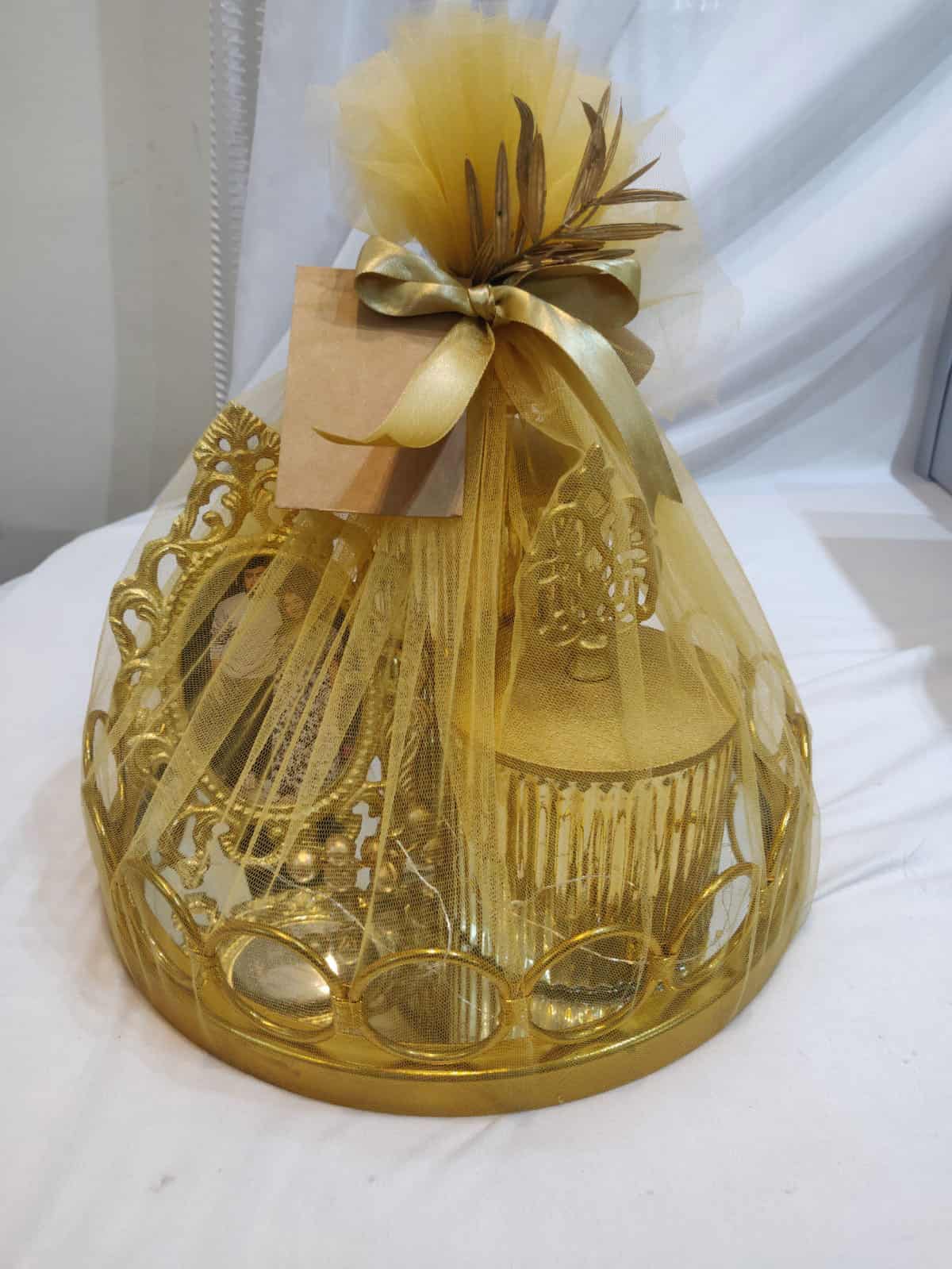 Decorative gold gift bag with a bow on a white background