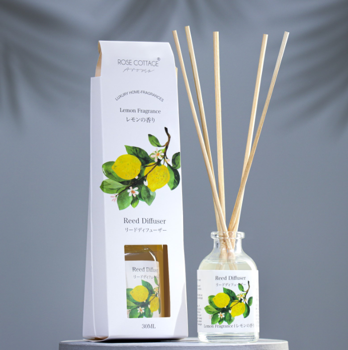 Reed diffuser set with packaging featuring lemon illustrations on a gray background
