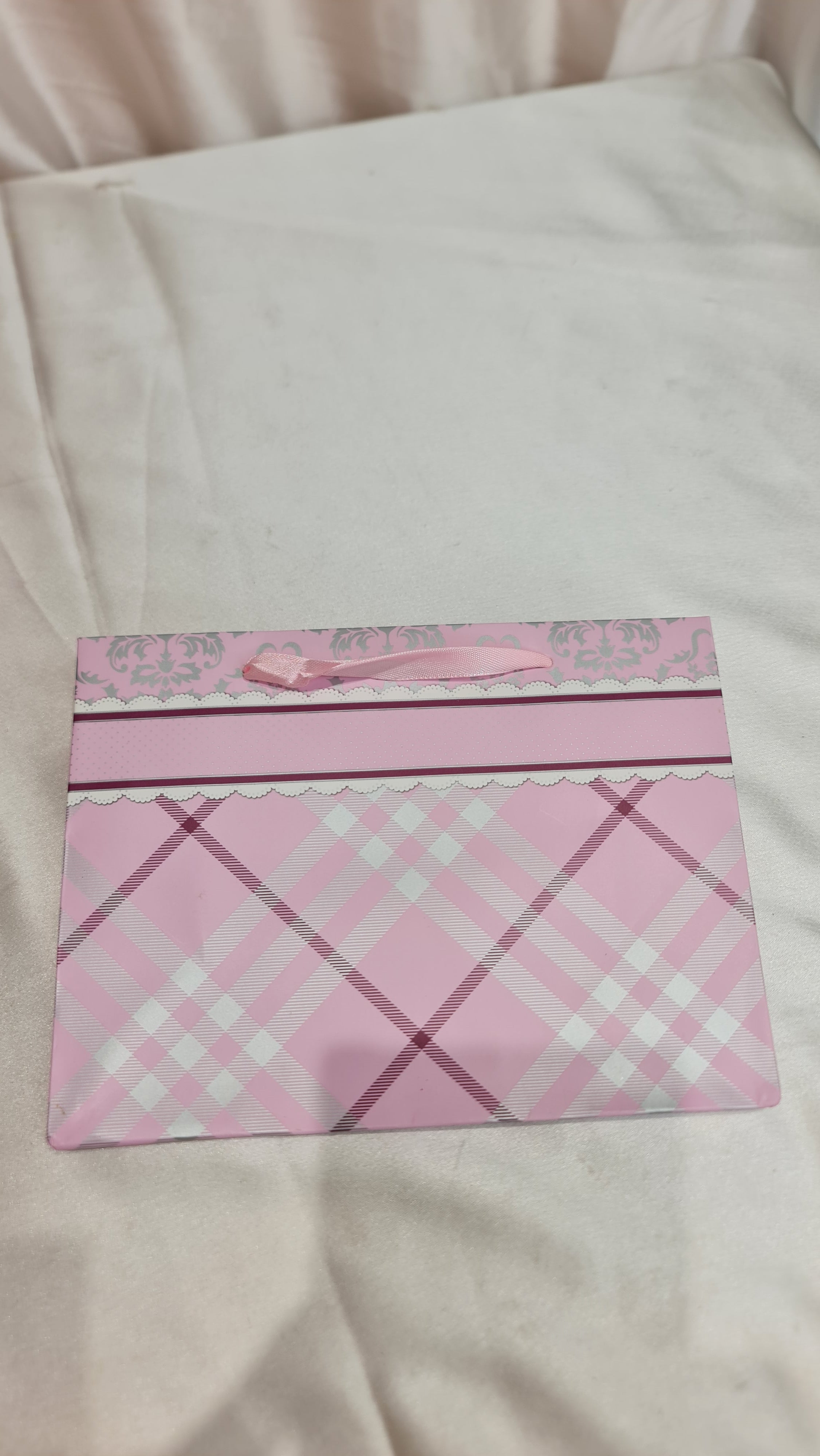 Pink plaid fabric on a white background