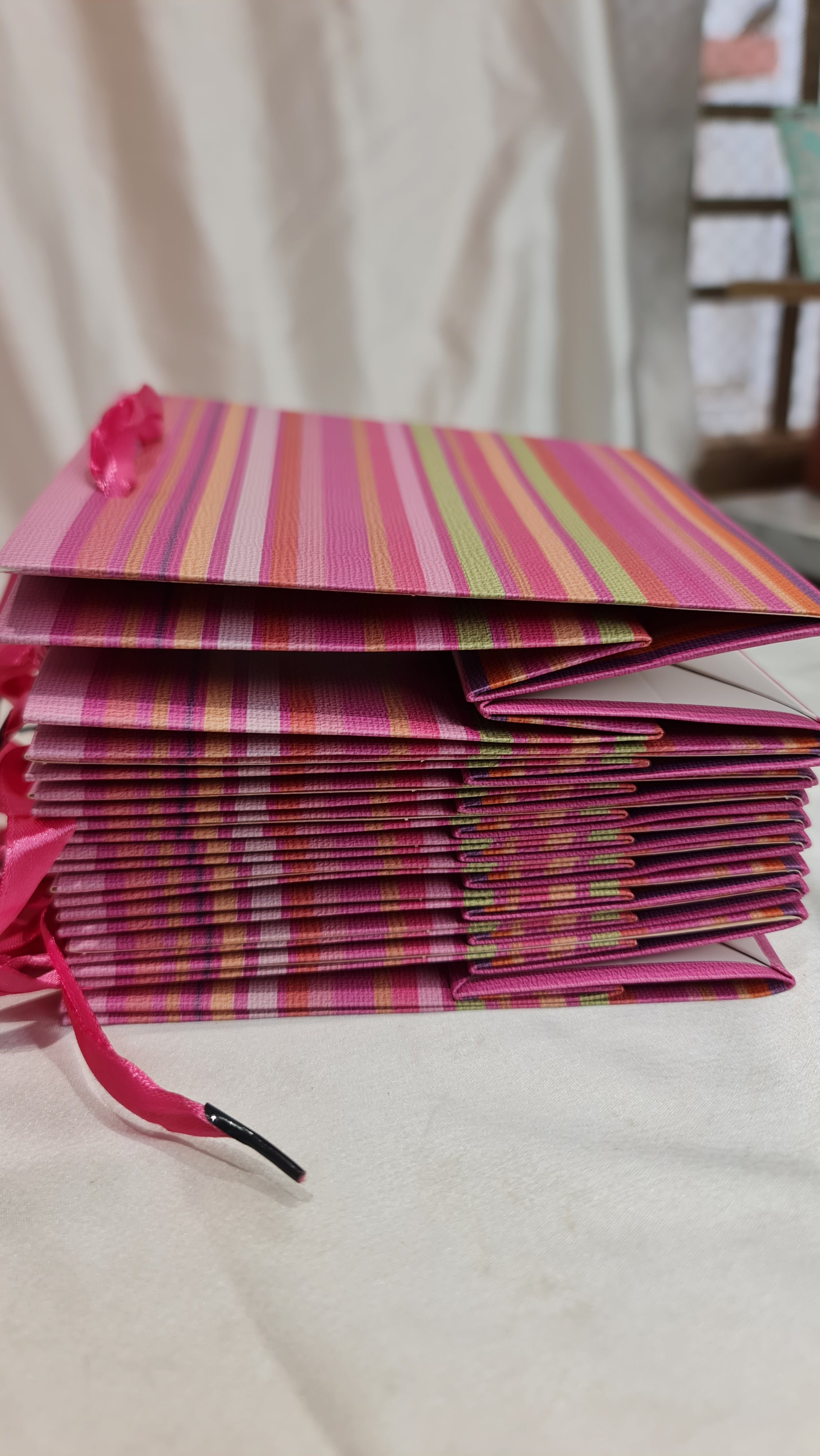 Striped pink and purple bag on a light background