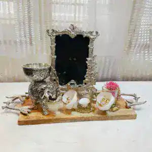 Decorative tray with elephant and shell design on a white surface