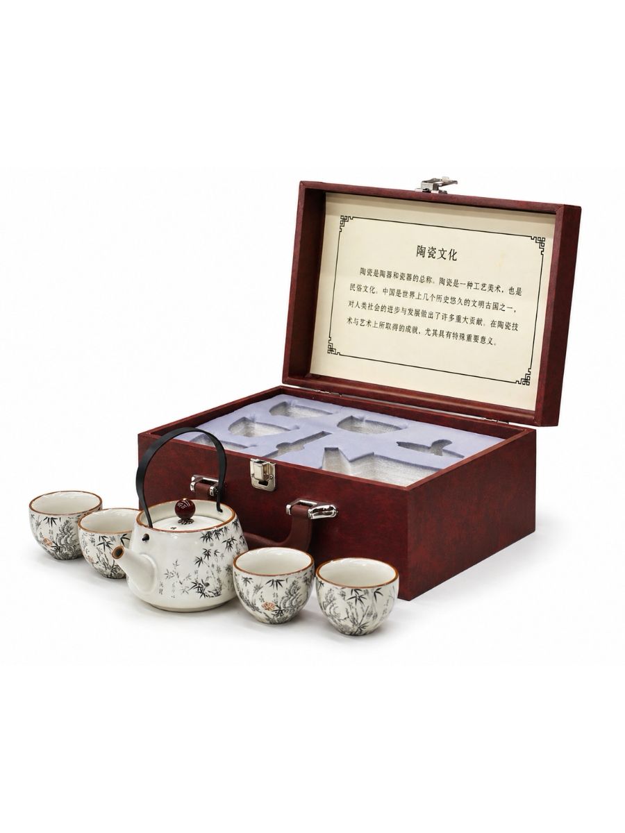 Tea set with teapot and cups in a wooden box on a white background