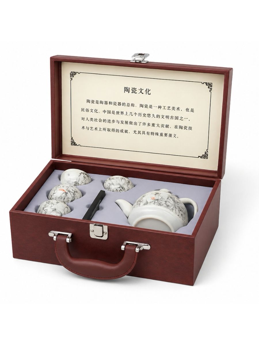 Tea set with teapot and cups in a wooden box on a white background
