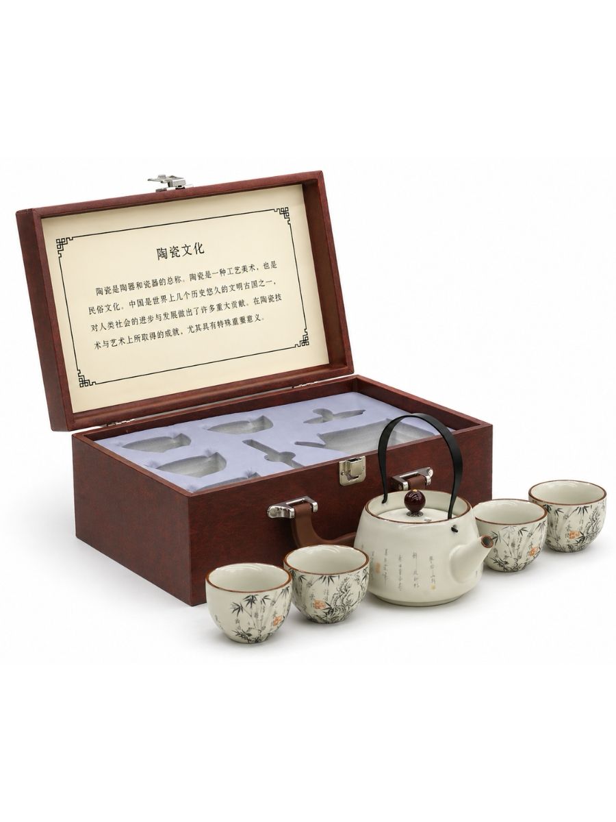 Tea set with teapot and cups in a wooden box on a white background