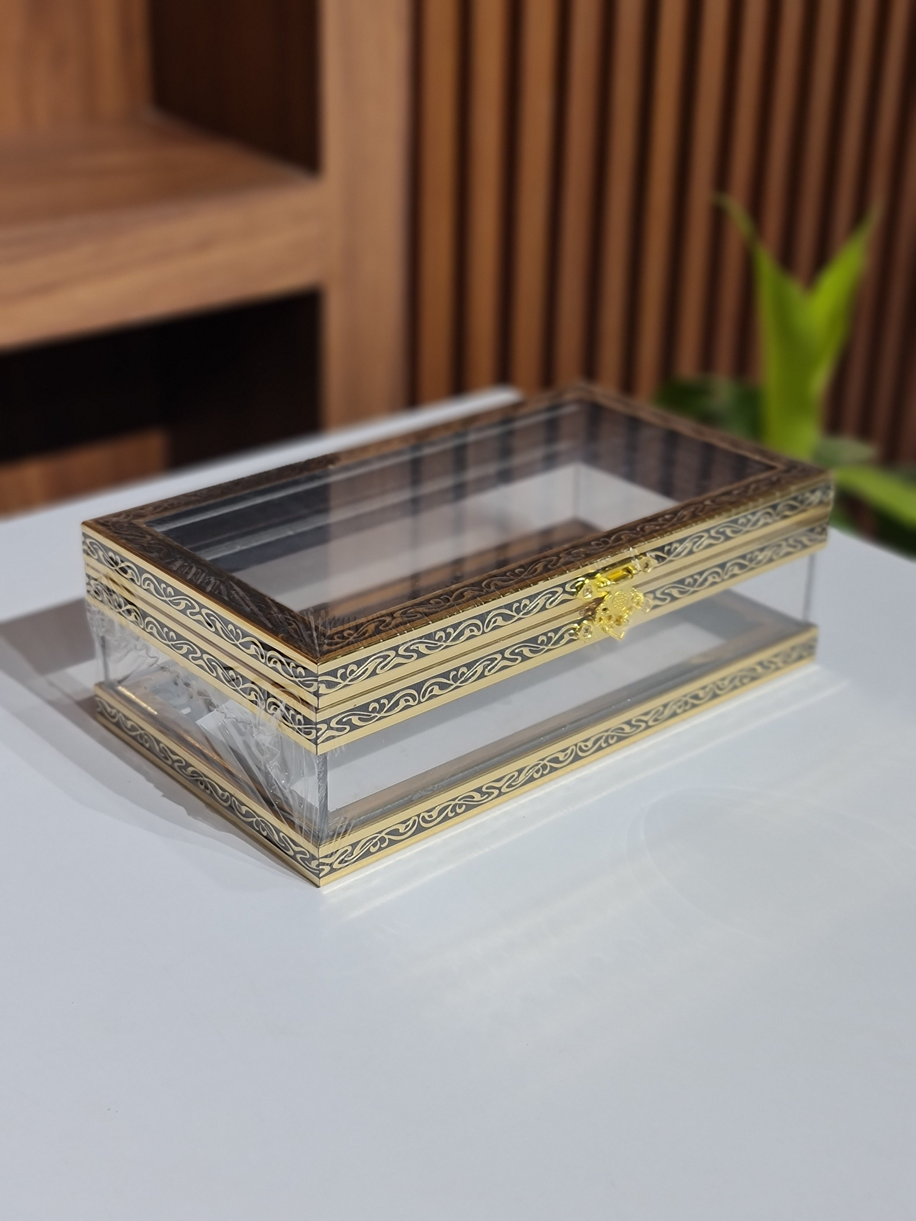 Decorative gold frame on a white surface with a blurred background