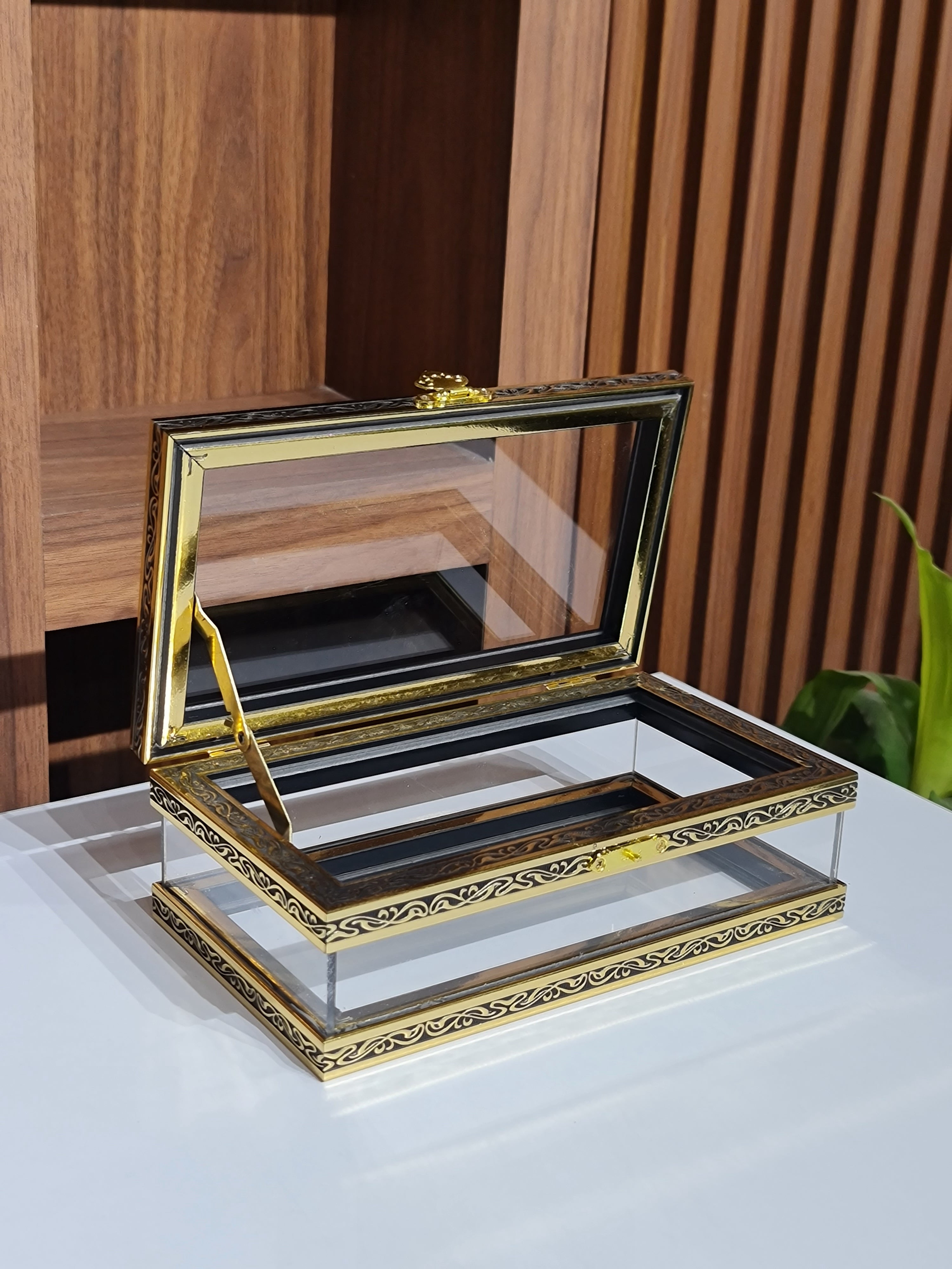 Two gold-framed picture frames on a wooden surface with a white background.