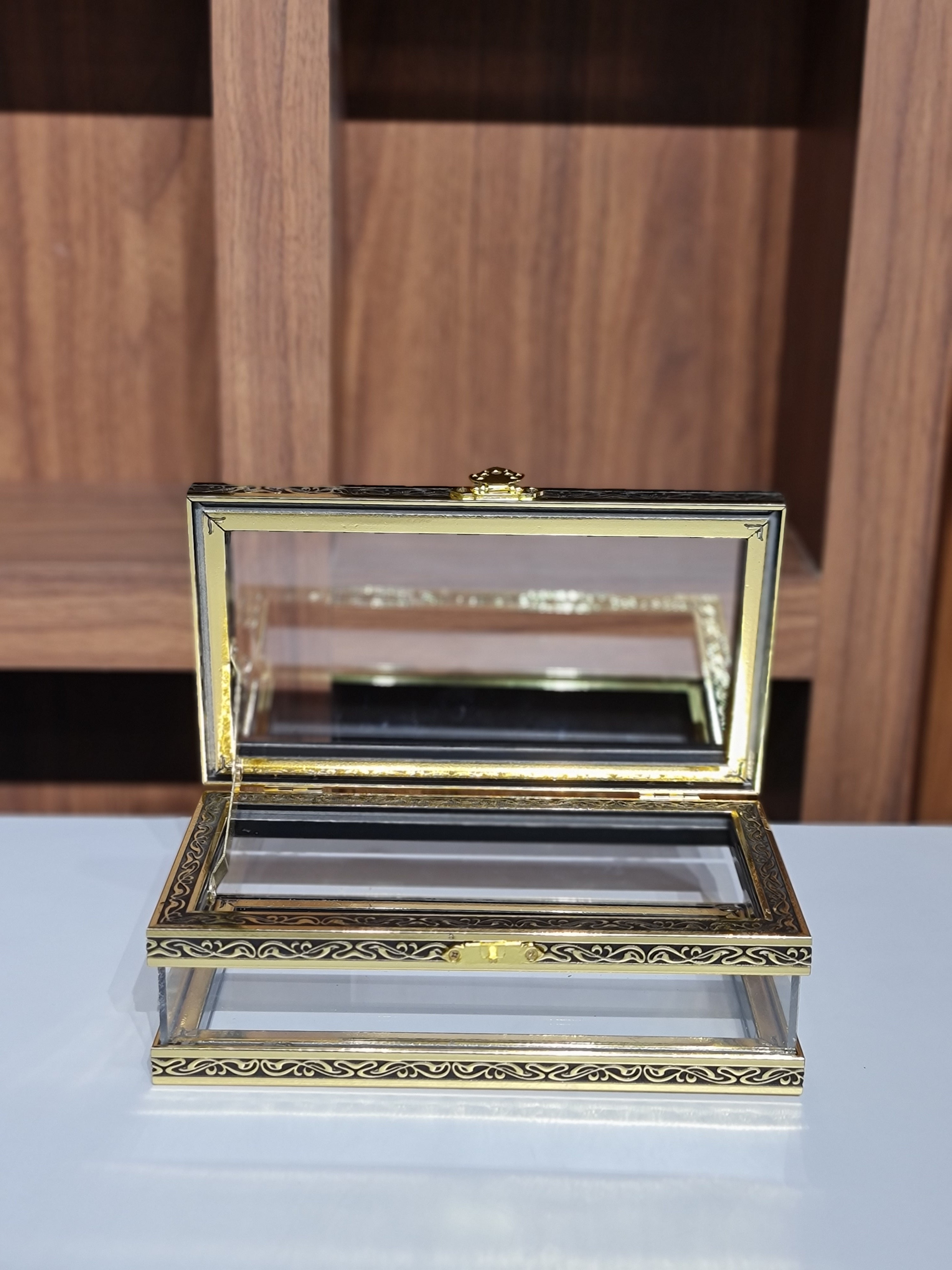 Decorative gold-framed mirror on a wooden shelf