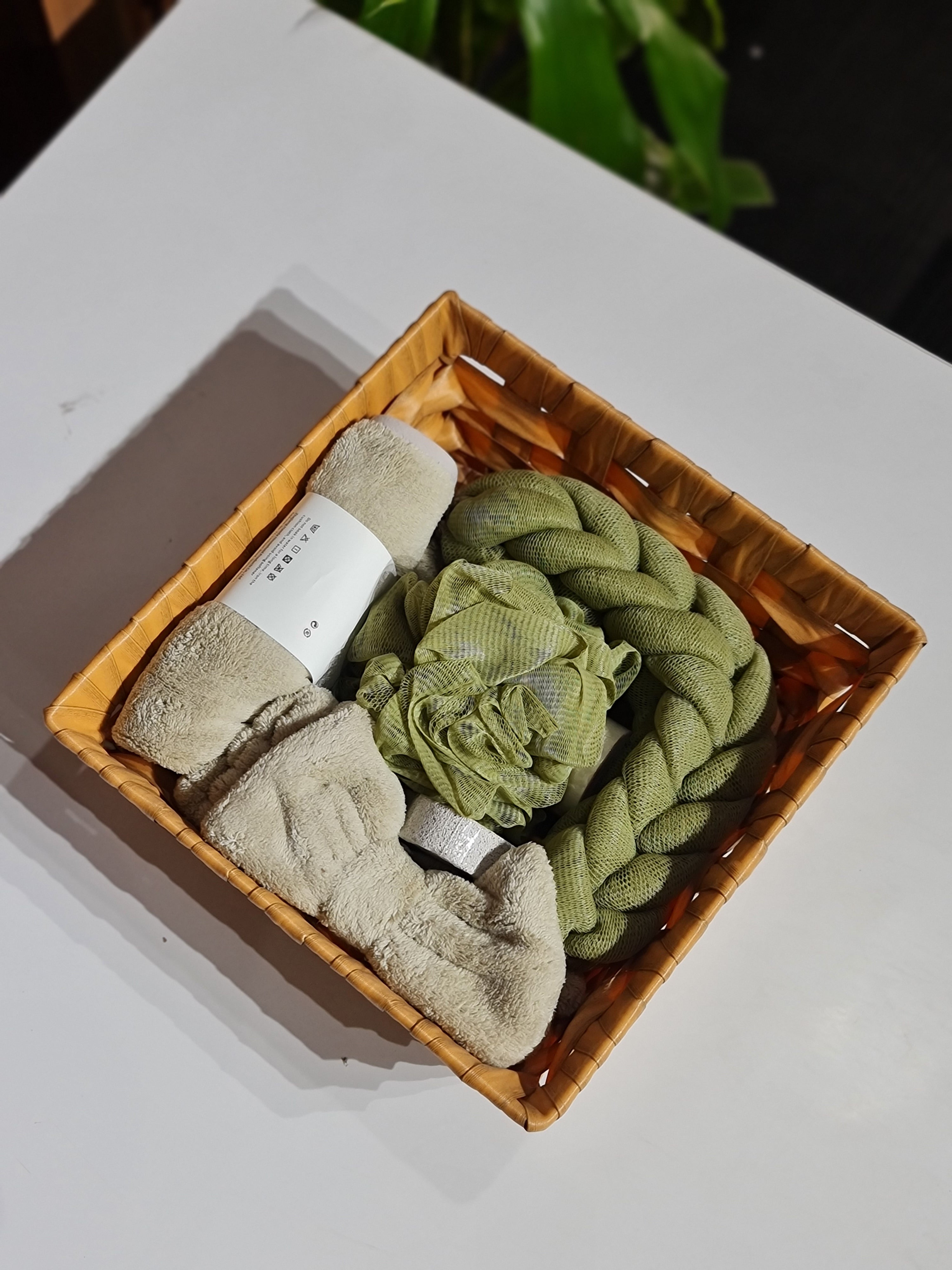 Basket with green and beige textured items on a white surface