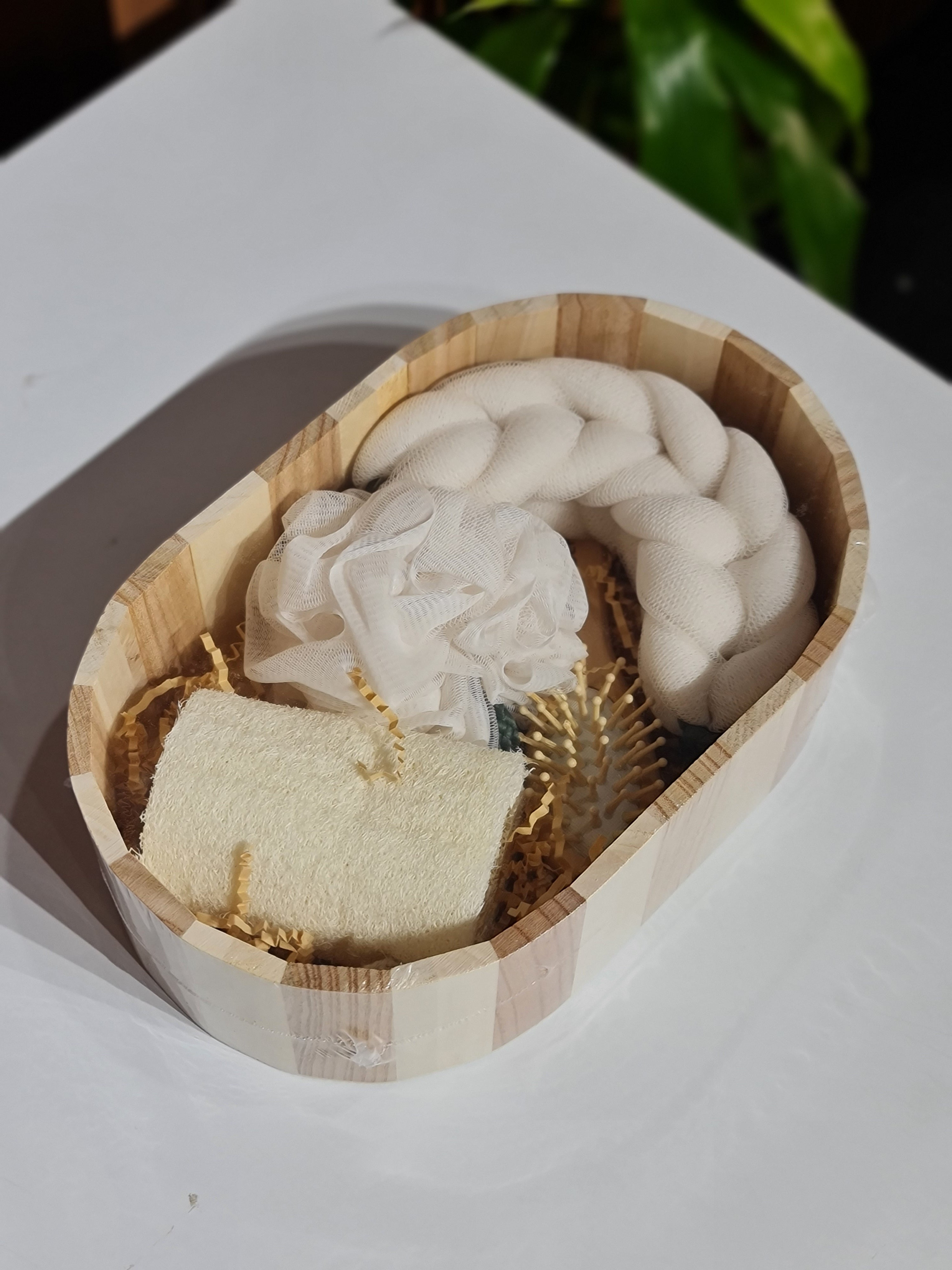 Wooden bowl with natural materials on a white surface