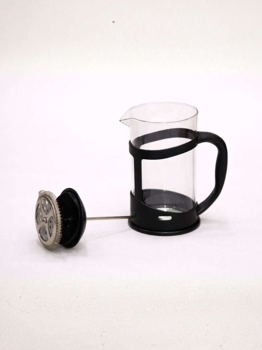 Black French press coffee maker with clear glass carafe on a white background