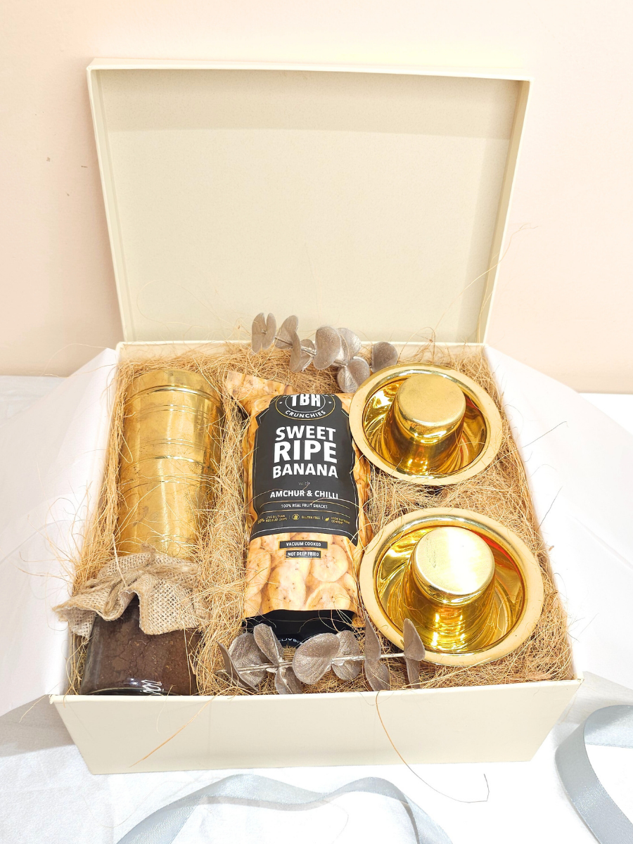 Gift set with candles and a bottle of wine in a decorative box.