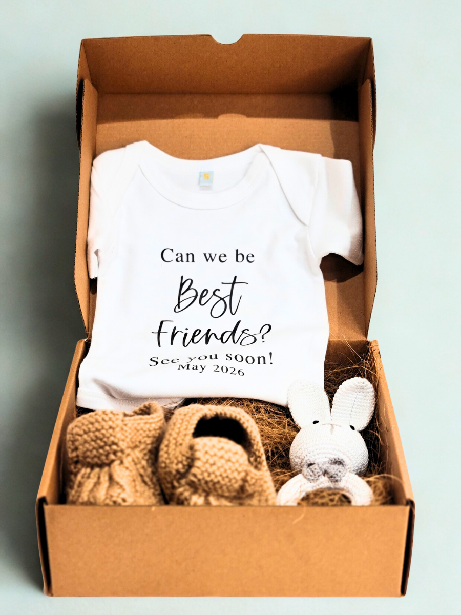 Baby onesie with 'Can we be Best Friends? See you soon!' text in a box with baby booties and a plush toy.