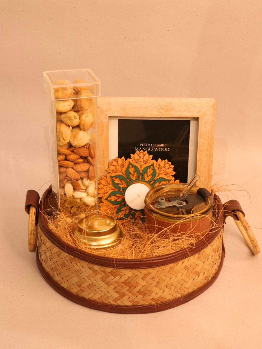 Decorative tray with a candle, small jar, and framed picture on a beige background