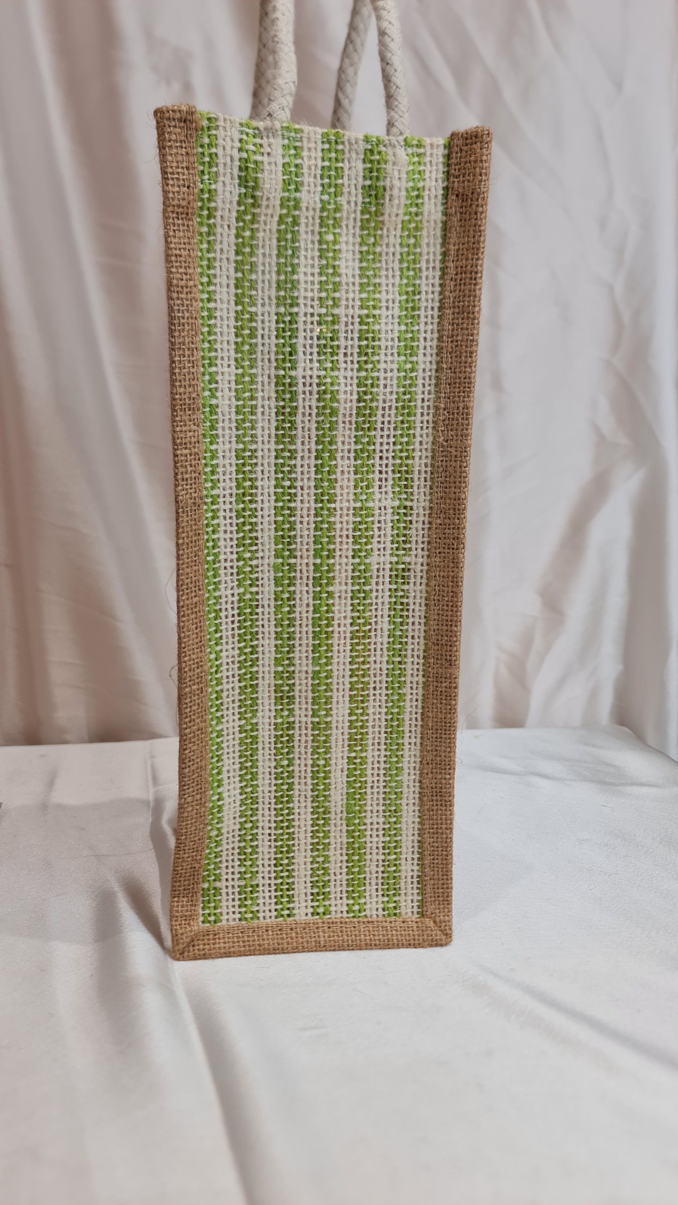 Rectangular woven patch with green and brown pattern on a white fabric background