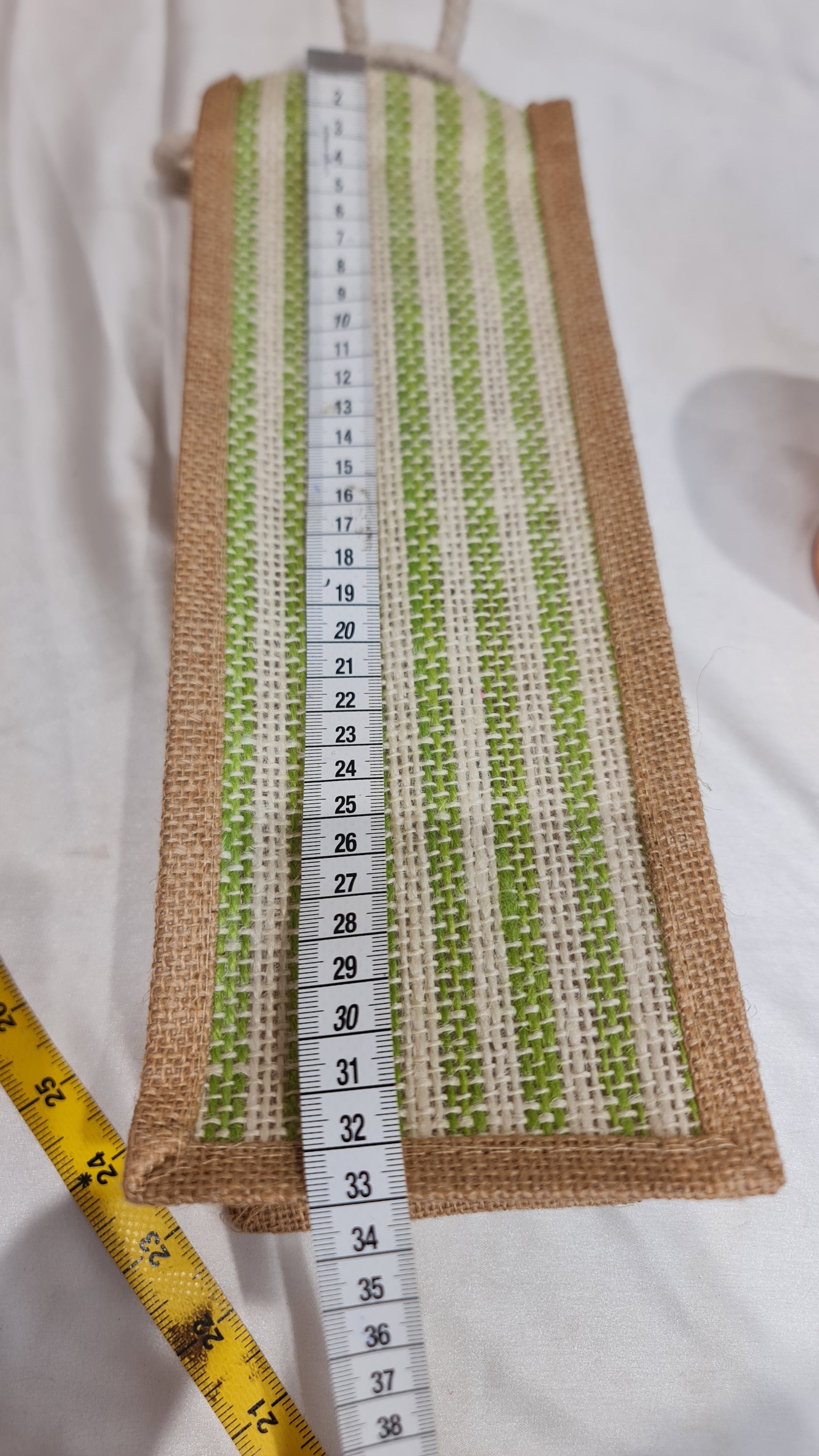 Stripes of fabric with a measuring tape on a white background