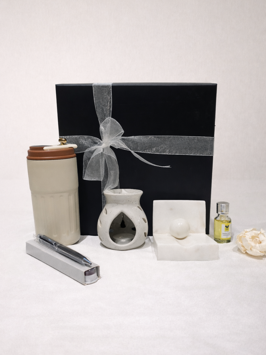 Set of home fragrance items including a diffuser, candle, and essential oil on a white background.