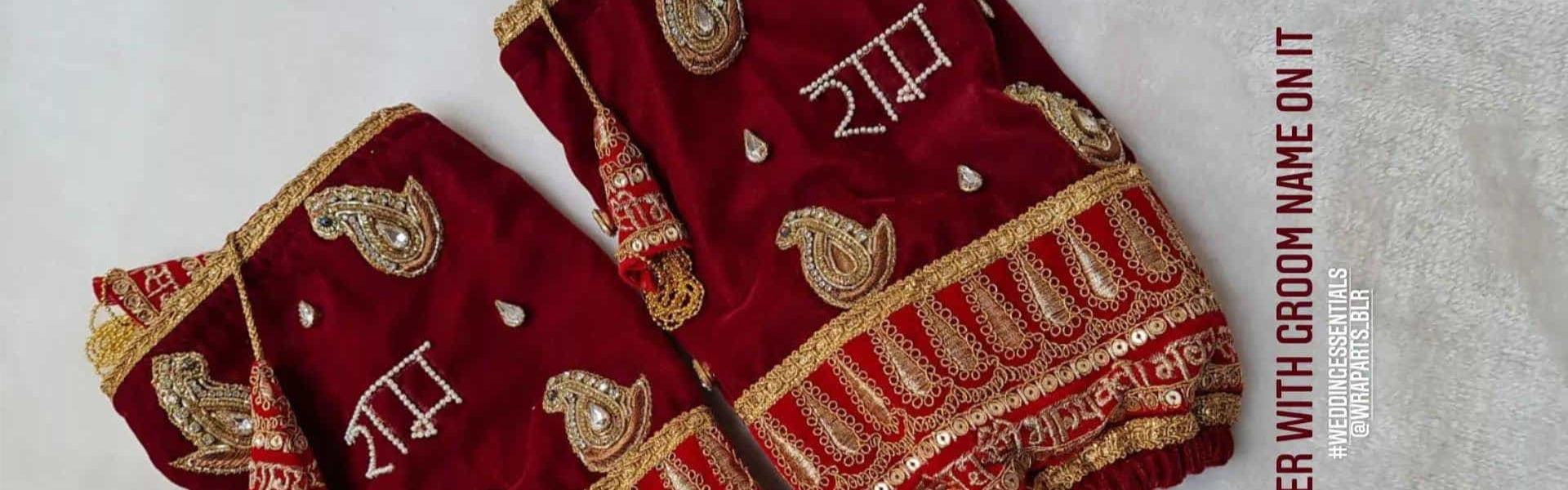 Red embroidered handkerchiefs with gold detailing on a light gray background