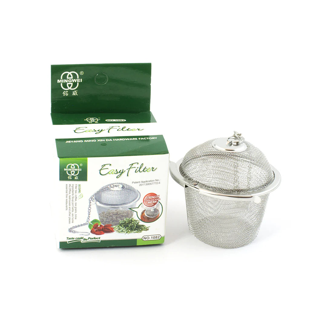 Metal tea filter with packaging on a white background