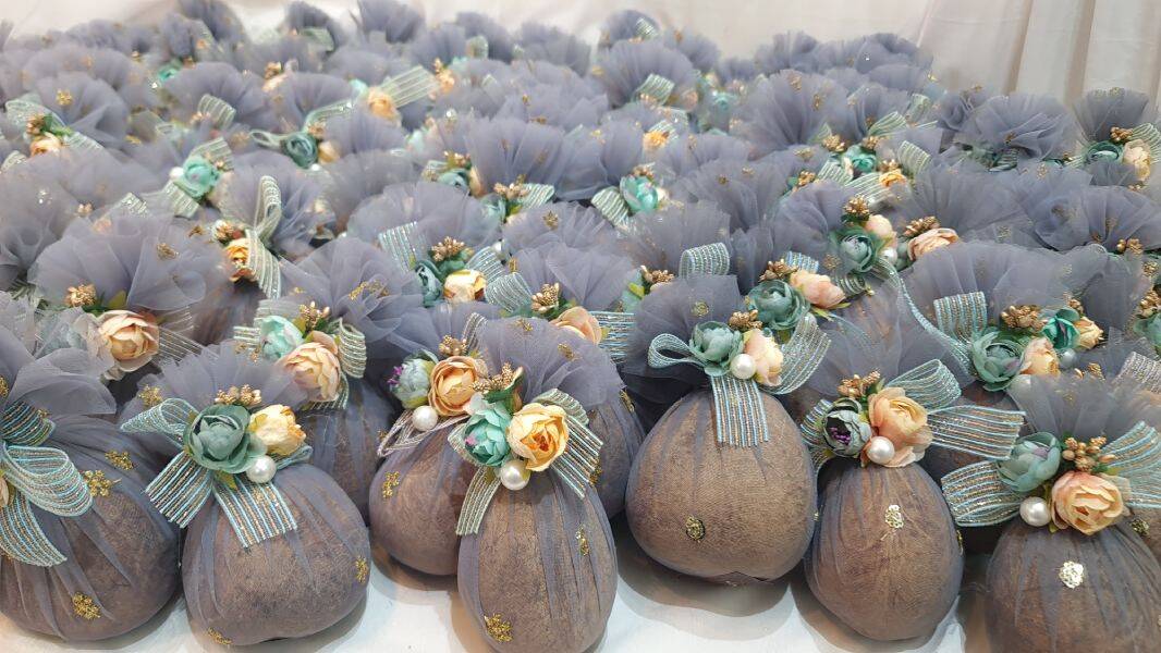 Decorative coconut with floral arrangements on a white background