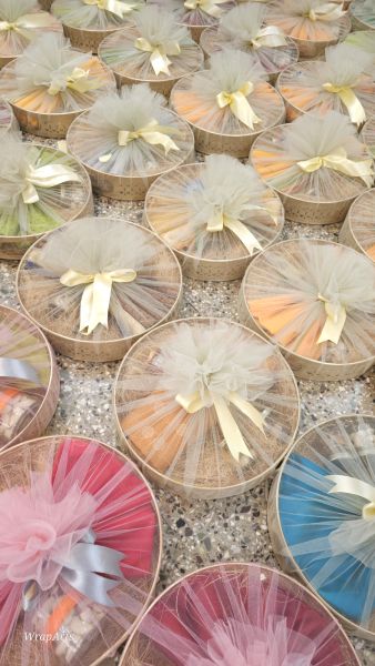 Decorative boxes with tulle and ribbons on a textured surface