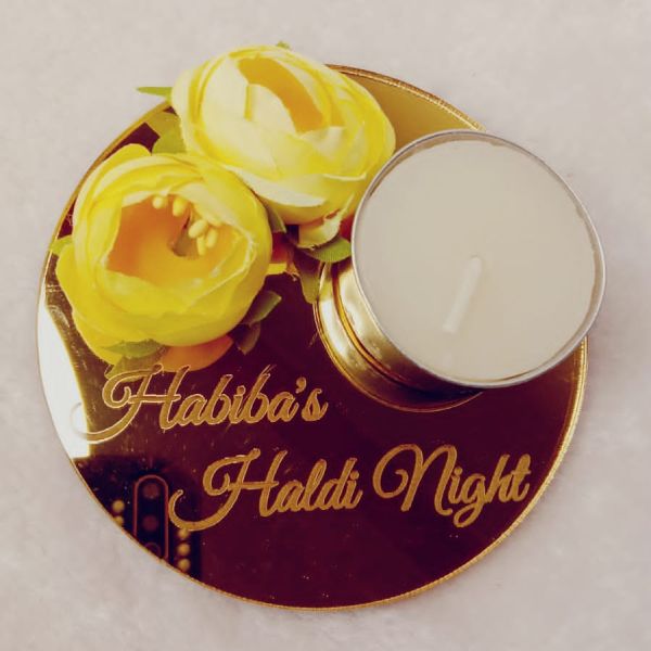 Decorative coaster with yellow flowers and a candle, featuring 'Habiba's Haldi Night' text.