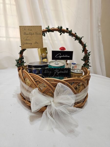 Wicker gift basket with a white bow on a white surface