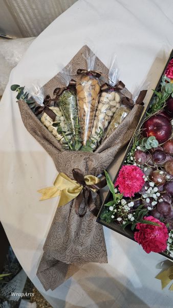 Bouquet of flowers wrapped in brown paper with a yellow ribbon on a white surface.