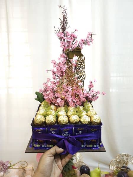 Bouquet of flowers with chocolate bars on a white background